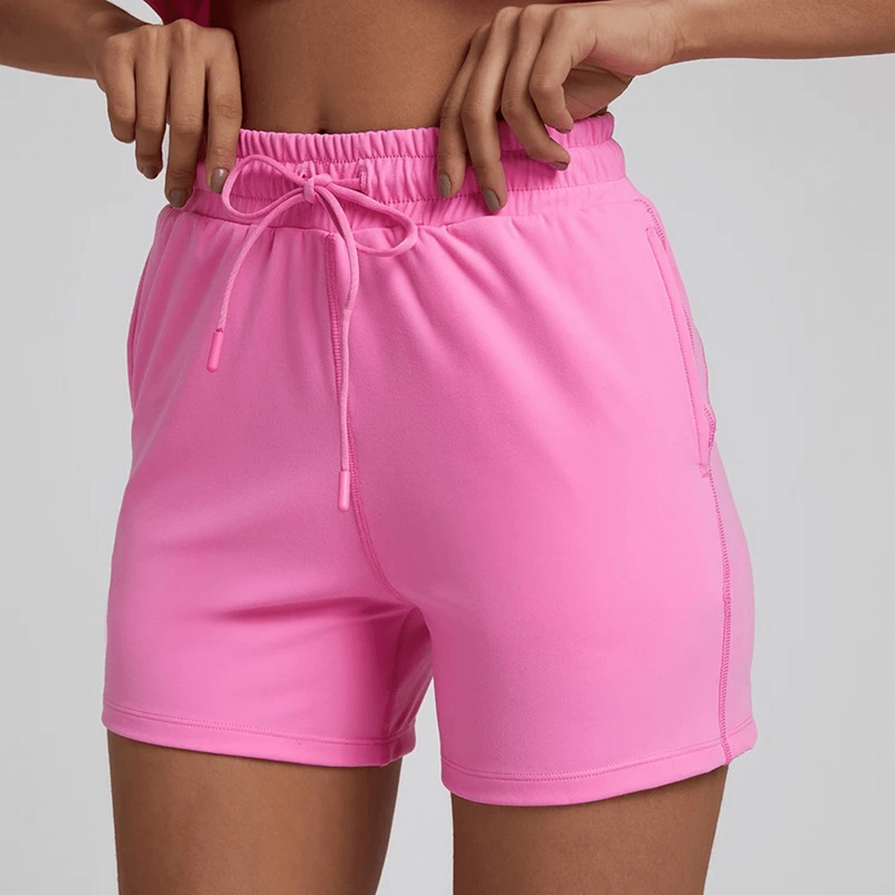 Bright pink women's workout shorts with elastic waistband, ideal for gym sessions. Made from nylon and spandex for ultimate flexibility.